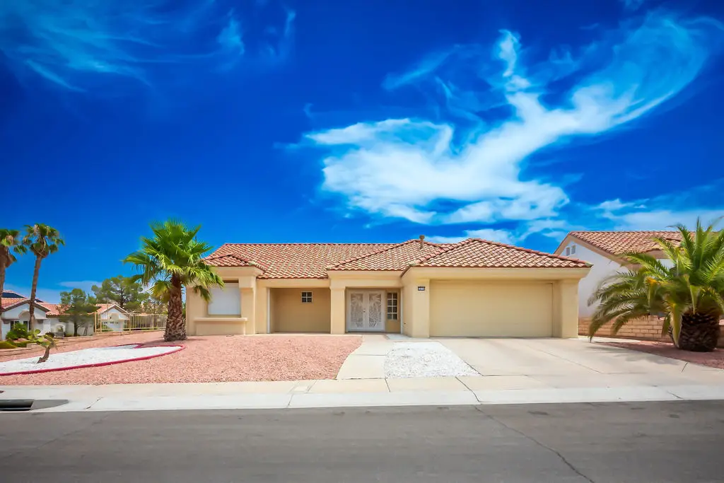 Sandalwood Floor Plan in Sun City Summerlin front exterior with desert landscaping, stucco finish, and covered entryway.
