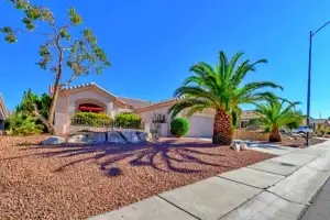 Tahoe Floor Plan in Sun City Summerlin front exterior with desert landscaping, arched entryway, and tile roof.