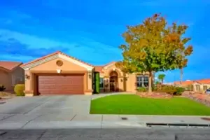 Versailles Floor Plan in Sun City Summerlin front exterior with desert landscaping, tile roof, and elegant single-story design.