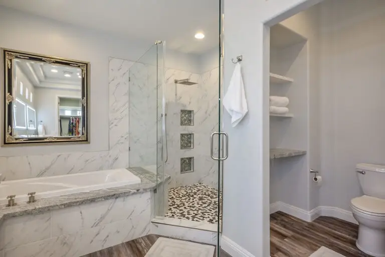 Aristocrat Floor Plan in Sun City Summerlin primary bathroom remodeled with marble and glass shower