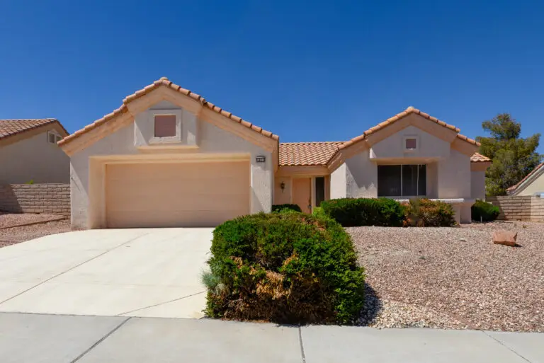 Sonora Floor Plan in Sun City Summerlin front exterior with desert landscaping, decorative rock beds, and tile roof.