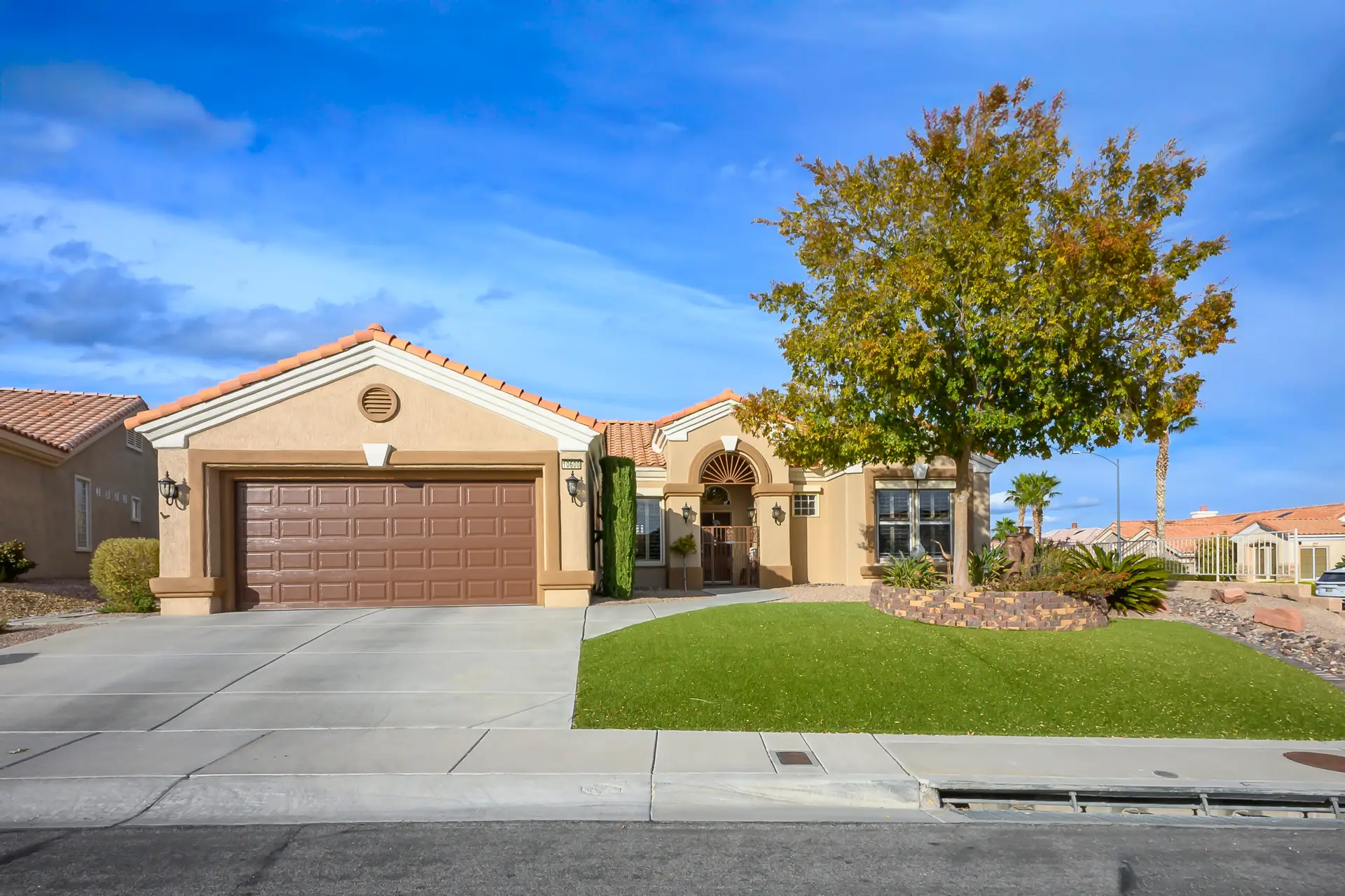Versailles Floor Plan in Sun City Summerlin front exterior with desert landscaping, tile roof, and elegant single-story design.