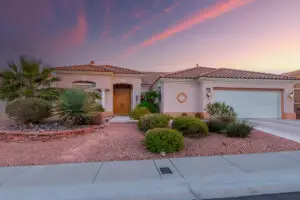Wendover Floor Plan in Sun City Summerlin front exterior of three-bedroom, three-bath home with tile roof and desert landscaping.